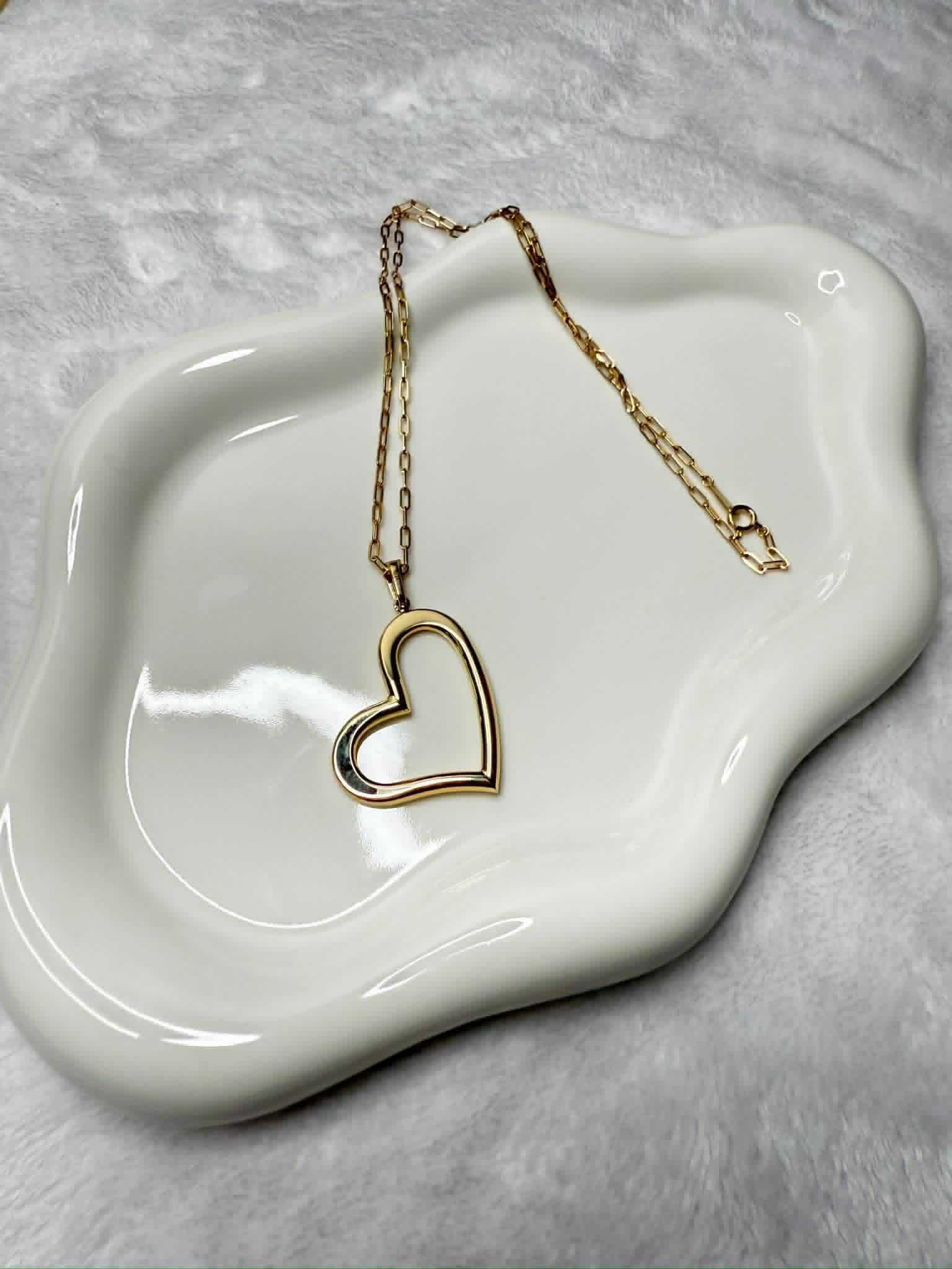 Gold open-heart pendant on a paperclip chain