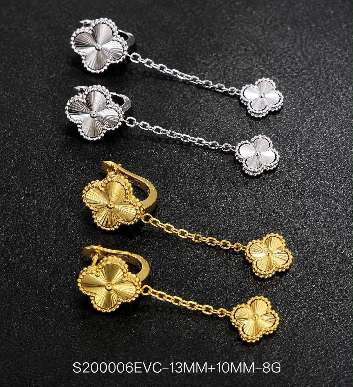 Two pairs of clover drop earrings in silver and gold tone