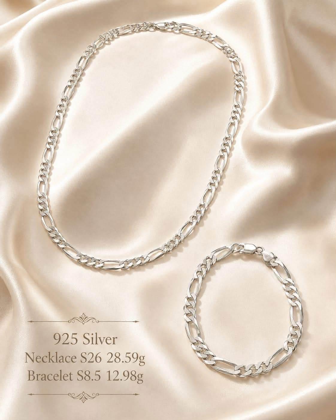 Sterling silver Figaro chain necklace and matching bracelet on cream silk